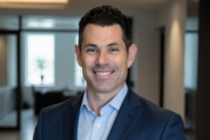 man in blue suit in front of an office